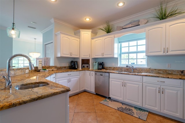 kitchen with decorative light fixtures, white cabinetry, stainless steel dishwasher, and sink