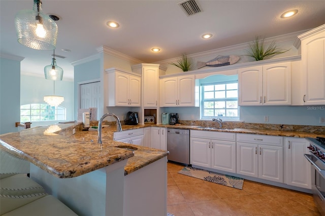 kitchen featuring pendant lighting, white cabinets, sink, and appliances with stainless steel finishes