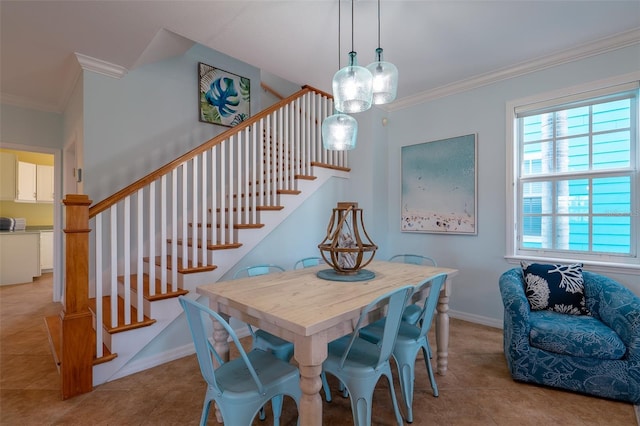 dining room featuring crown molding, light tile patterned floors, and a chandelier