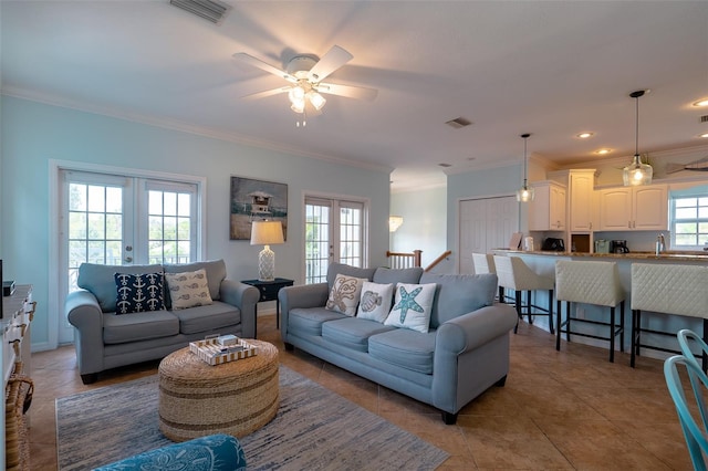 living room featuring french doors, tile patterned floors, sink, crown molding, and ceiling fan