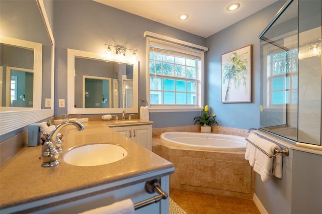 bathroom featuring plus walk in shower, vanity, and tile patterned floors