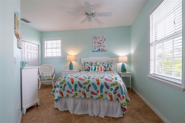 tiled bedroom featuring a closet and ceiling fan