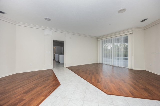 unfurnished room with crown molding and light wood-type flooring