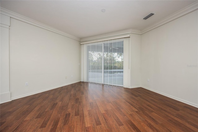 spare room with crown molding and dark wood-type flooring