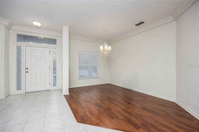 entryway with light hardwood / wood-style flooring, an inviting chandelier, and crown molding