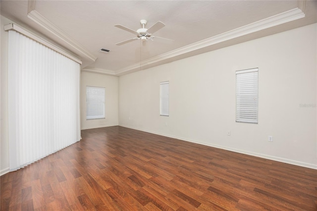 spare room featuring dark hardwood / wood-style floors, ceiling fan, and ornamental molding