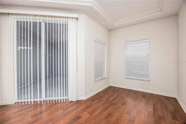 empty room with ornamental molding and dark wood-type flooring