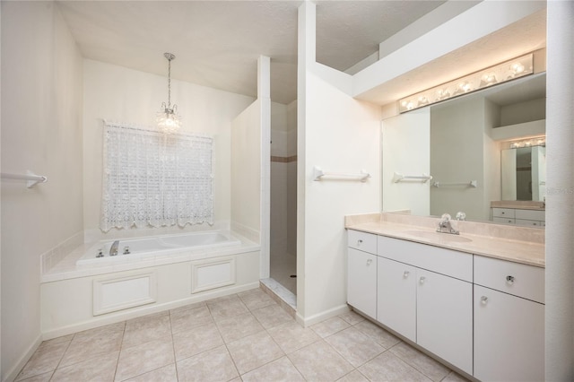 bathroom with tile patterned flooring, vanity, a tub to relax in, and a chandelier