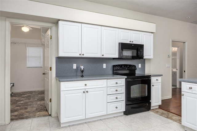 kitchen with black appliances, decorative backsplash, and white cabinets