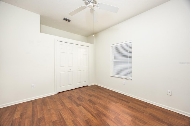 unfurnished bedroom featuring ceiling fan, a closet, and dark hardwood / wood-style floors