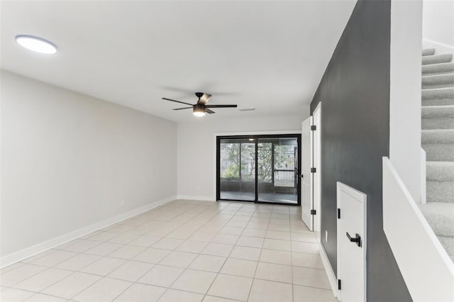 unfurnished room featuring light tile patterned floors and ceiling fan