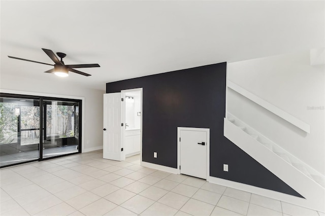 spare room featuring ceiling fan and light tile patterned floors