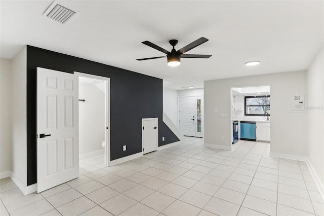 tiled empty room with ceiling fan and sink