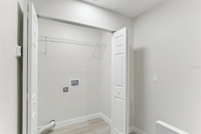 washroom with hookup for a washing machine and light hardwood / wood-style flooring