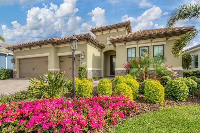 mediterranean / spanish-style home with a garage