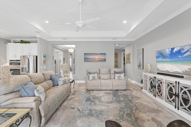 living room featuring ceiling fan, ornamental molding, and a tray ceiling