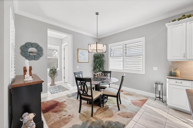 dining space with light tile patterned floors, crown molding, and a notable chandelier