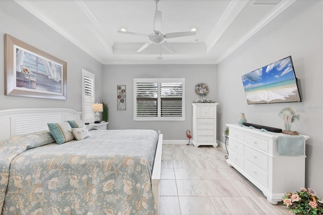 tiled bedroom featuring ceiling fan, a raised ceiling, and ornamental molding