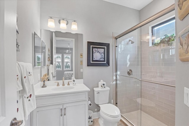 bathroom with ceiling fan, a shower with door, vanity, and a healthy amount of sunlight