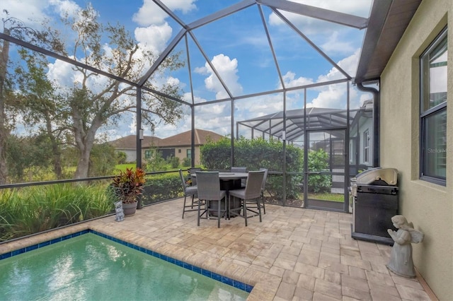 view of patio / terrace featuring glass enclosure and grilling area