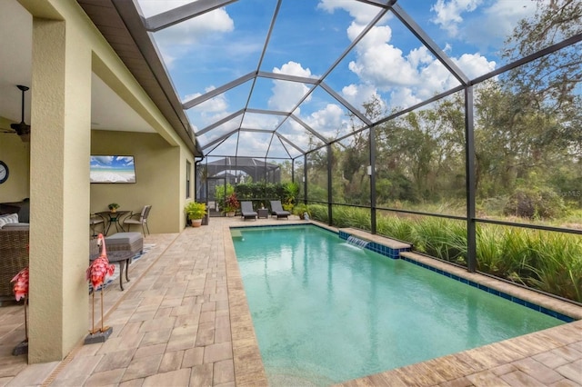 view of swimming pool featuring a lanai and a patio area