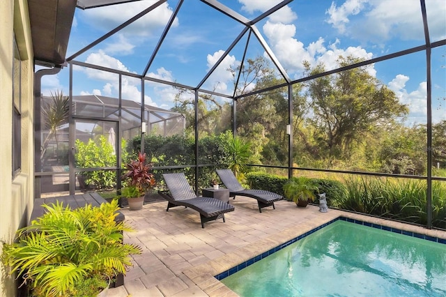 view of pool with a lanai and a patio area