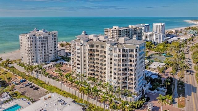 birds eye view of property with a water view and a view of the beach