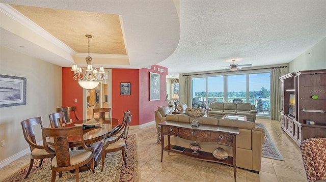 dining room featuring a textured ceiling, crown molding, light tile patterned floors, and ceiling fan with notable chandelier