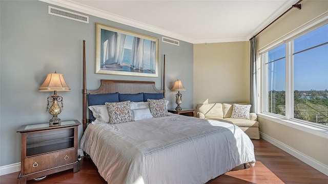 bedroom with crown molding and dark hardwood / wood-style flooring