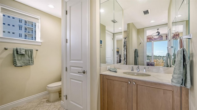 bathroom featuring tile patterned floors, vanity, and toilet