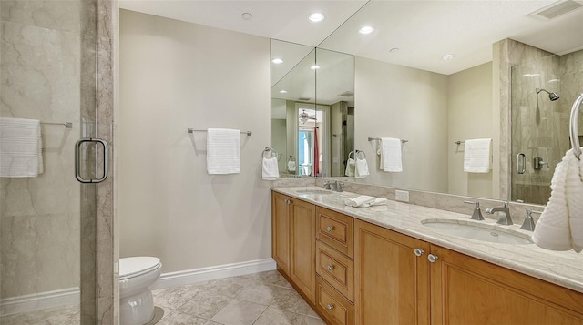 bathroom featuring tile patterned flooring, vanity, toilet, and a shower with shower door