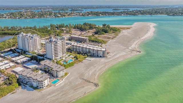 birds eye view of property featuring a water view and a beach view