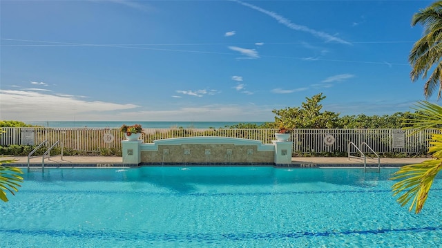 view of swimming pool with a water view