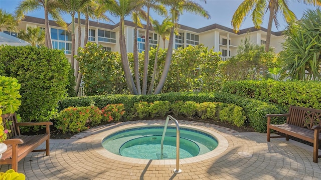 view of swimming pool with an in ground hot tub