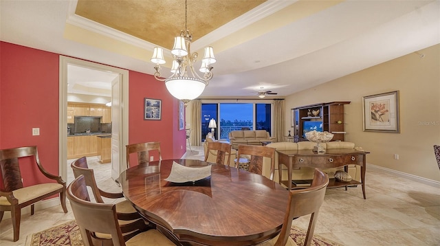 dining room featuring ornamental molding, a tray ceiling, light tile patterned floors, and a notable chandelier