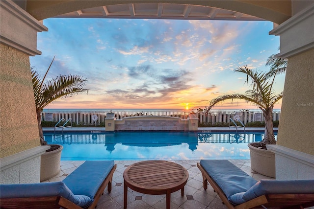 pool at dusk with a jacuzzi