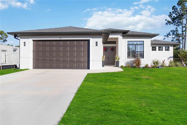 prairie-style house with a front yard and a garage