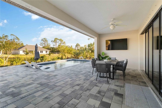 view of patio featuring a fenced in pool and ceiling fan