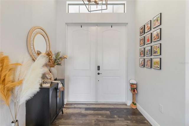 foyer featuring dark hardwood / wood-style floors and a notable chandelier