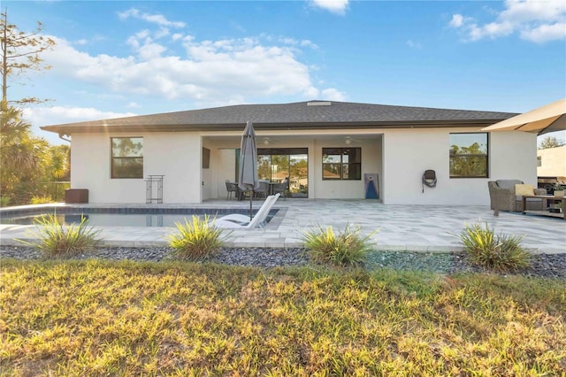 rear view of property with a patio and ceiling fan