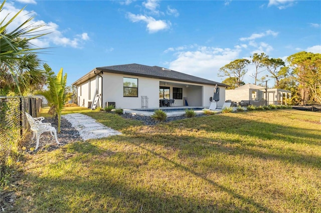 rear view of house featuring a patio area and a yard