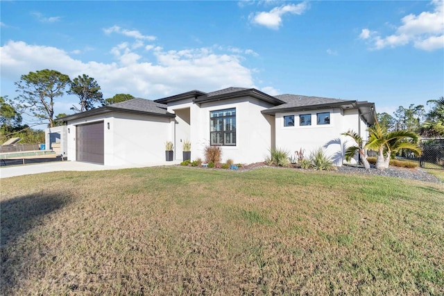 view of front of home with a front lawn and a garage