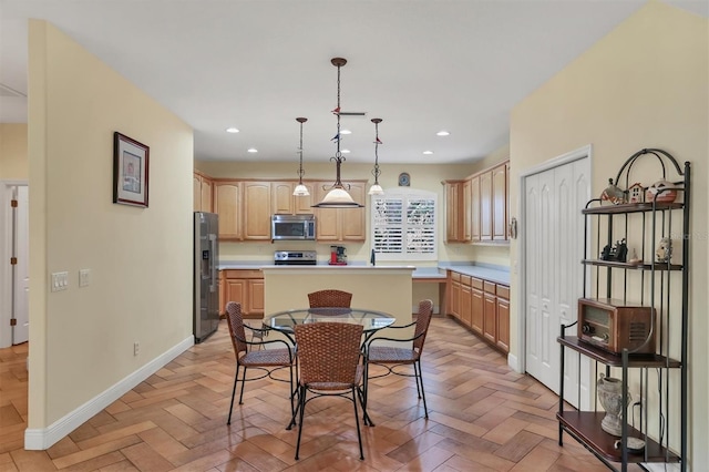 kitchen with hanging light fixtures, light brown cabinetry, a kitchen island, stainless steel appliances, and light parquet flooring