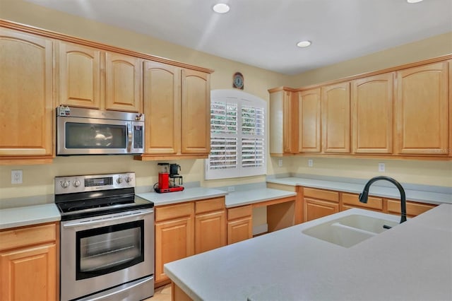 kitchen featuring light brown cabinetry, sink, and appliances with stainless steel finishes