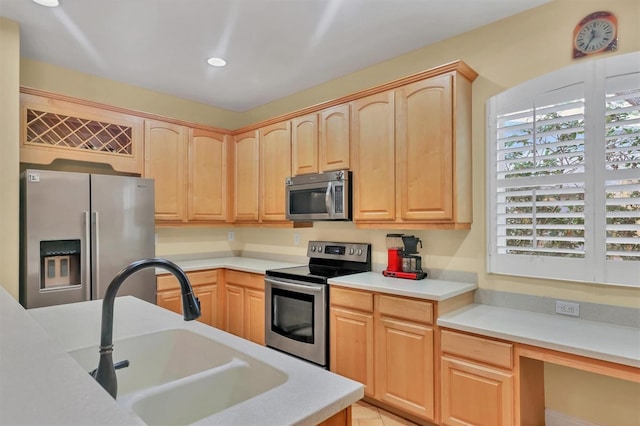 kitchen featuring light brown cabinetry, stainless steel appliances, light tile patterned floors, and sink