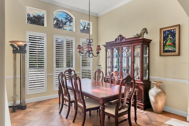 dining space featuring a chandelier, light parquet floors, and crown molding