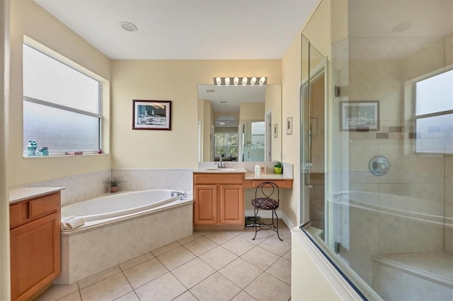 bathroom with tile patterned floors, vanity, and independent shower and bath