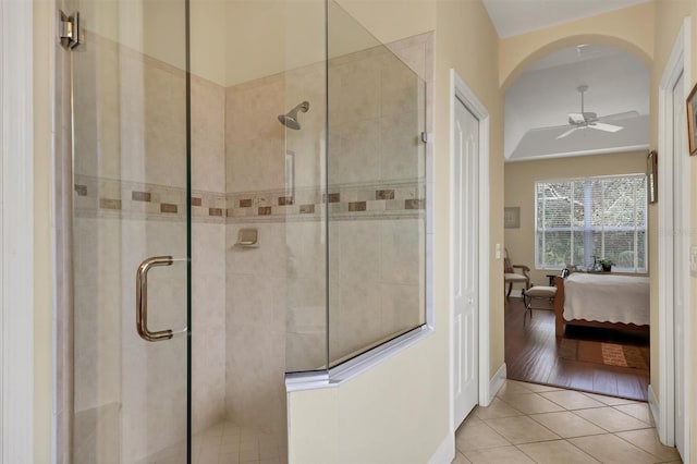 bathroom featuring tile patterned flooring, an enclosed shower, and ceiling fan