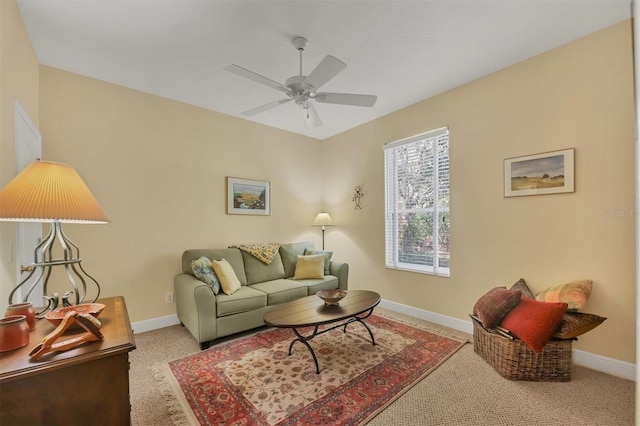 carpeted living room with ceiling fan