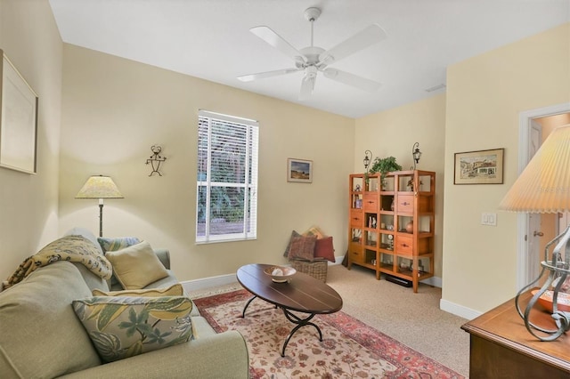 carpeted living room with ceiling fan